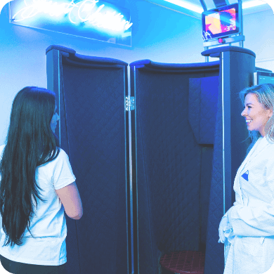 woman smiling at cryotherapy specialists before she hops in