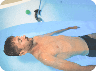 float tank therapy with man smiling because he is so relaxed