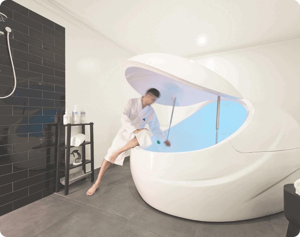 man hopping into float therapy pod sydney
